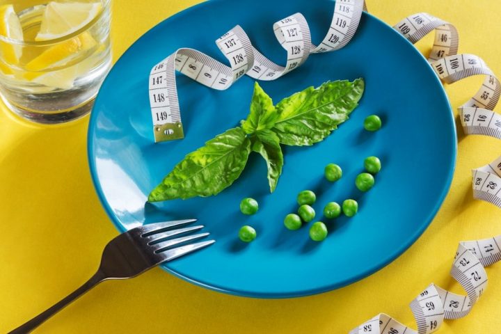 Diet blue plate with centimeter peas and basil
